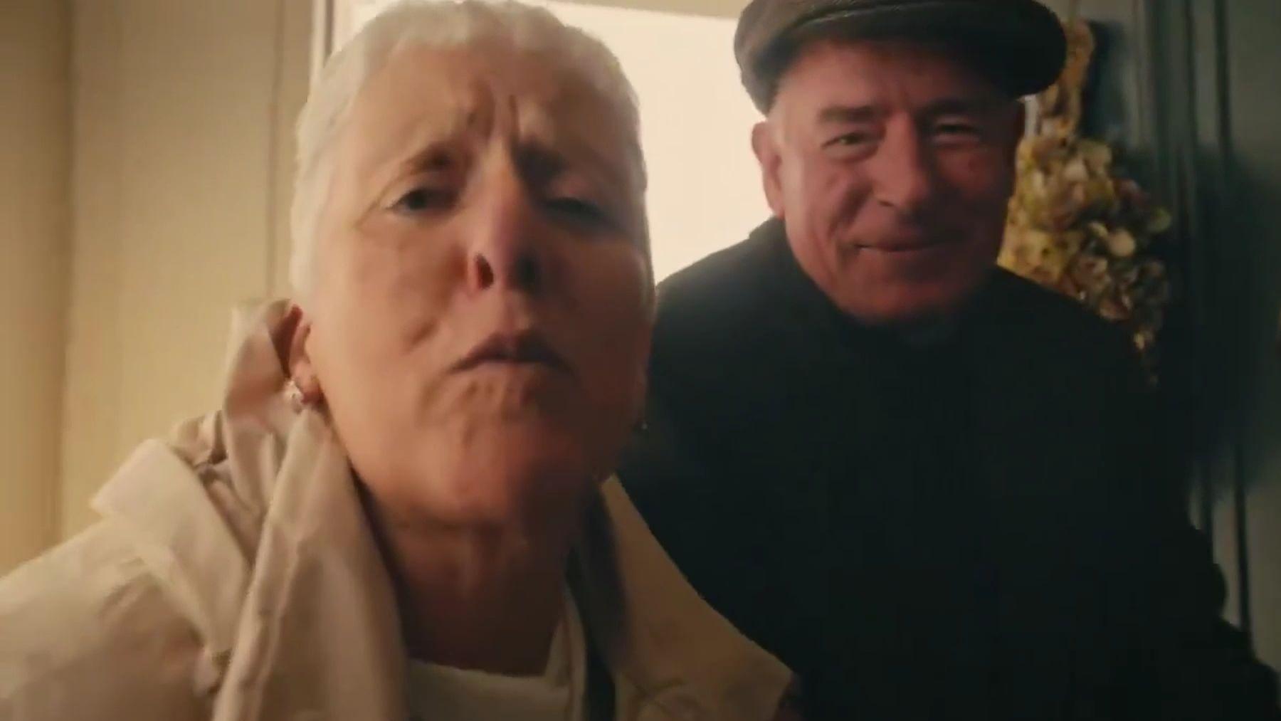 Grandparents hugging a boy