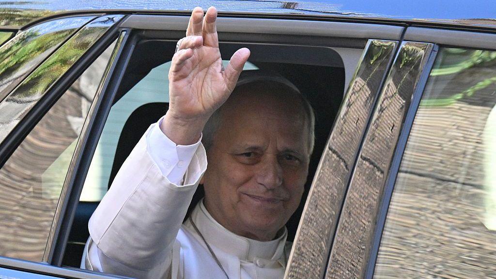 Pope Leo XIV waves from a car as he leaves the Vatican before entering Rome’s Gemelli Hospital