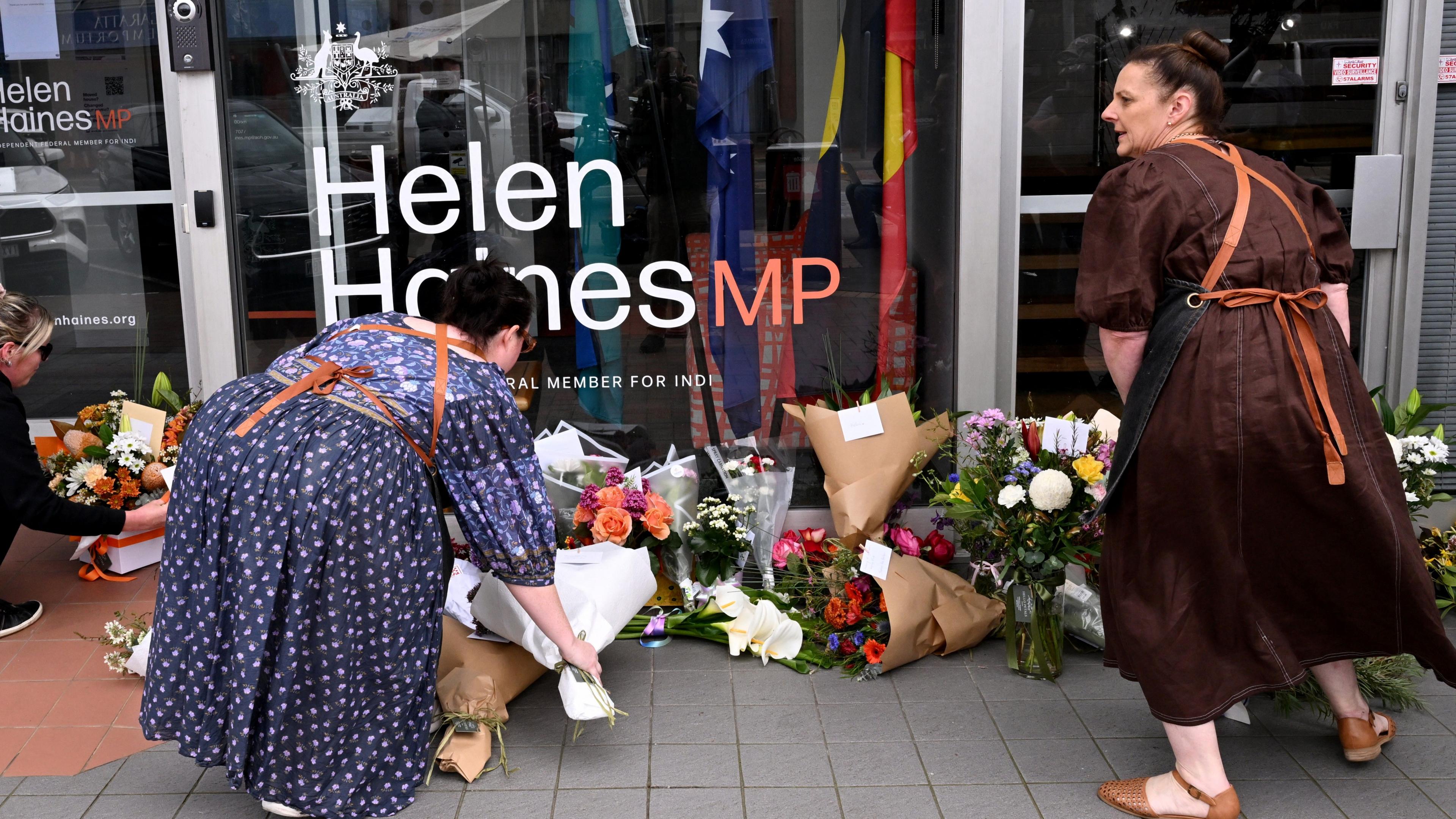 Women leaving flowers outside Helen Haines’s office