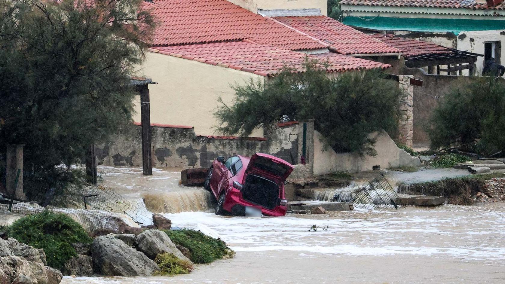 A damaged red car in a flooded area near Marseille