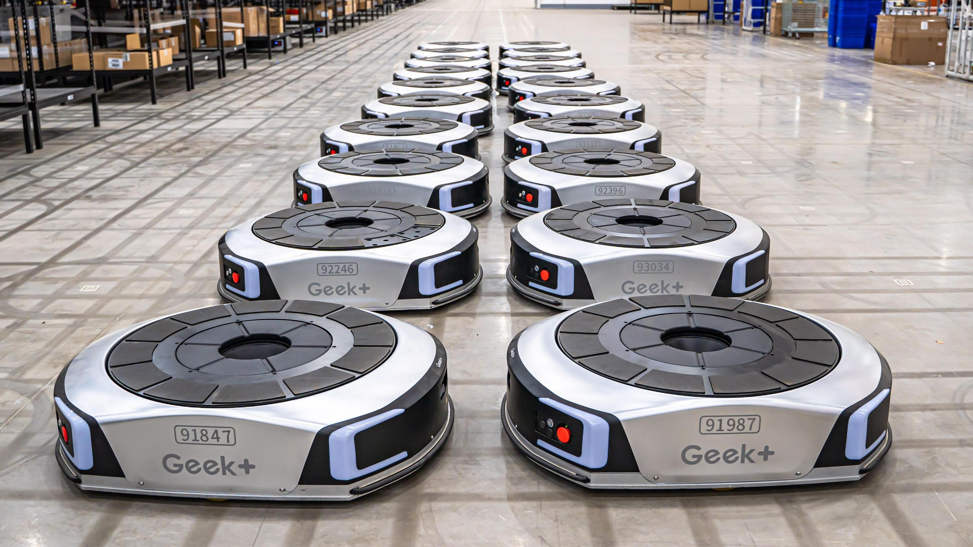 Geek+ floor robots moving shelves in a UK warehouse
