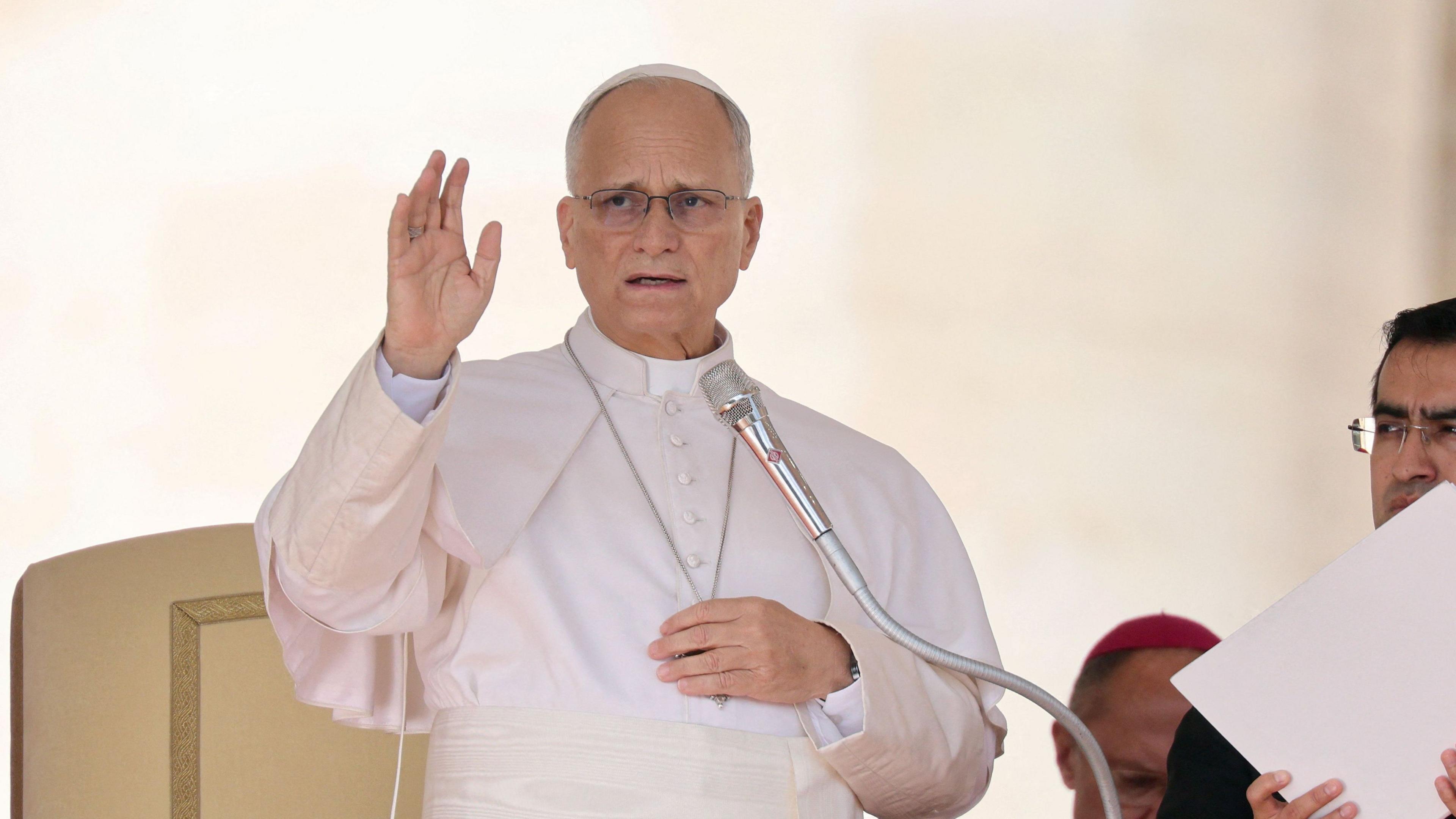Pope Leo speaks into a microphone