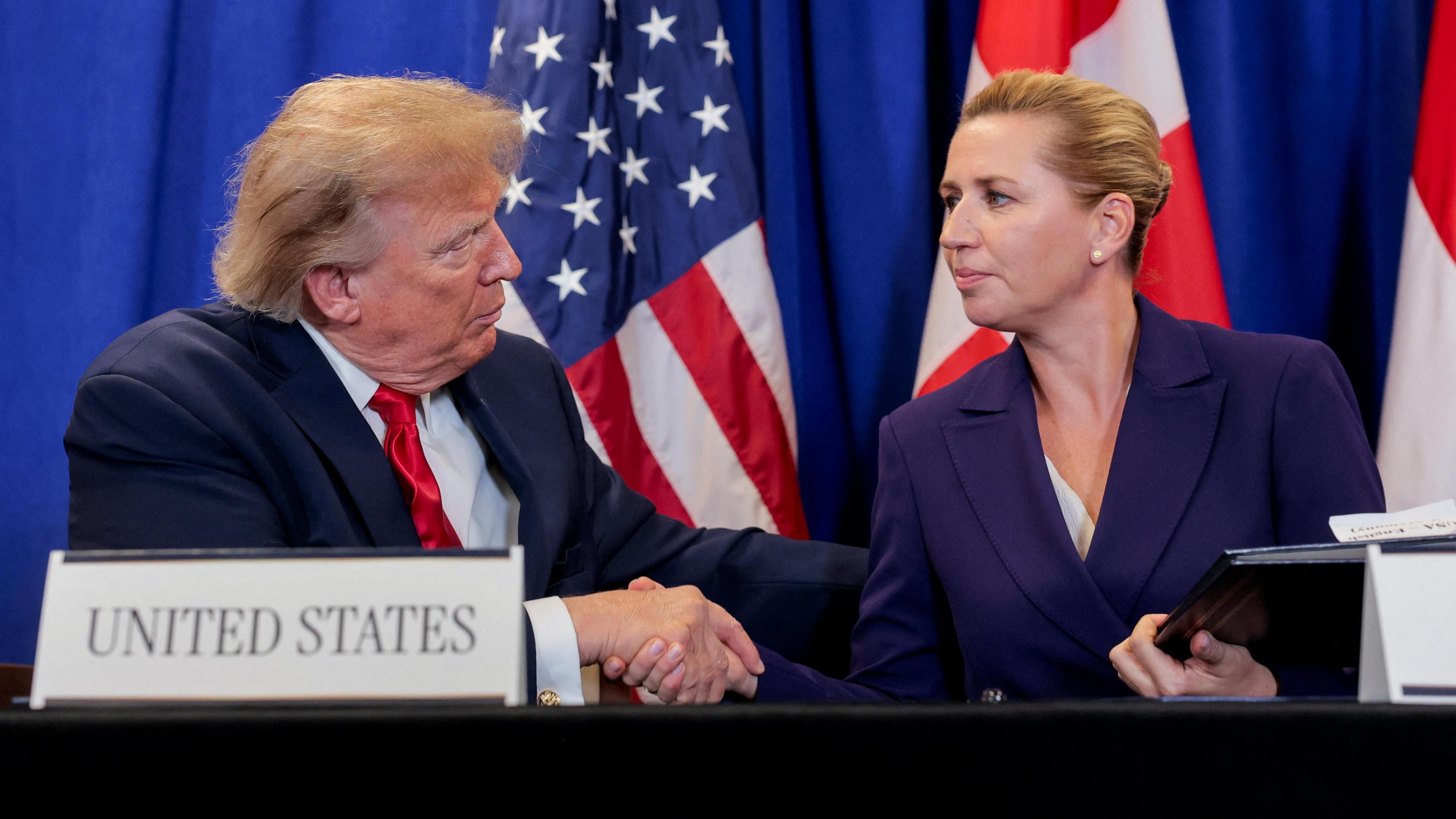 US President Donald Trump shakes hands with Danish Prime Minister Mette Frederiksen at the signing event