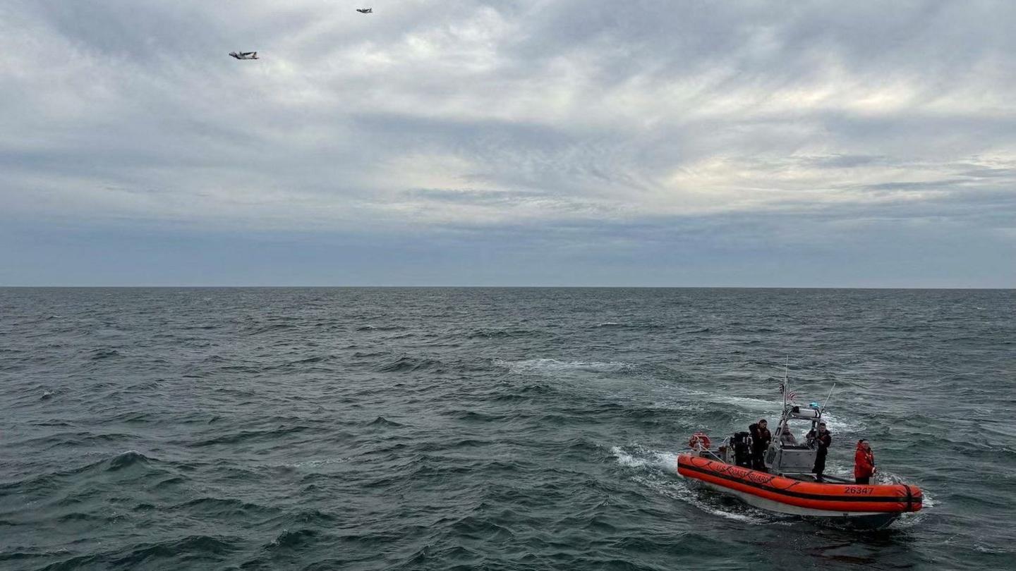 Red U.S. Coast Guard vessel in sea