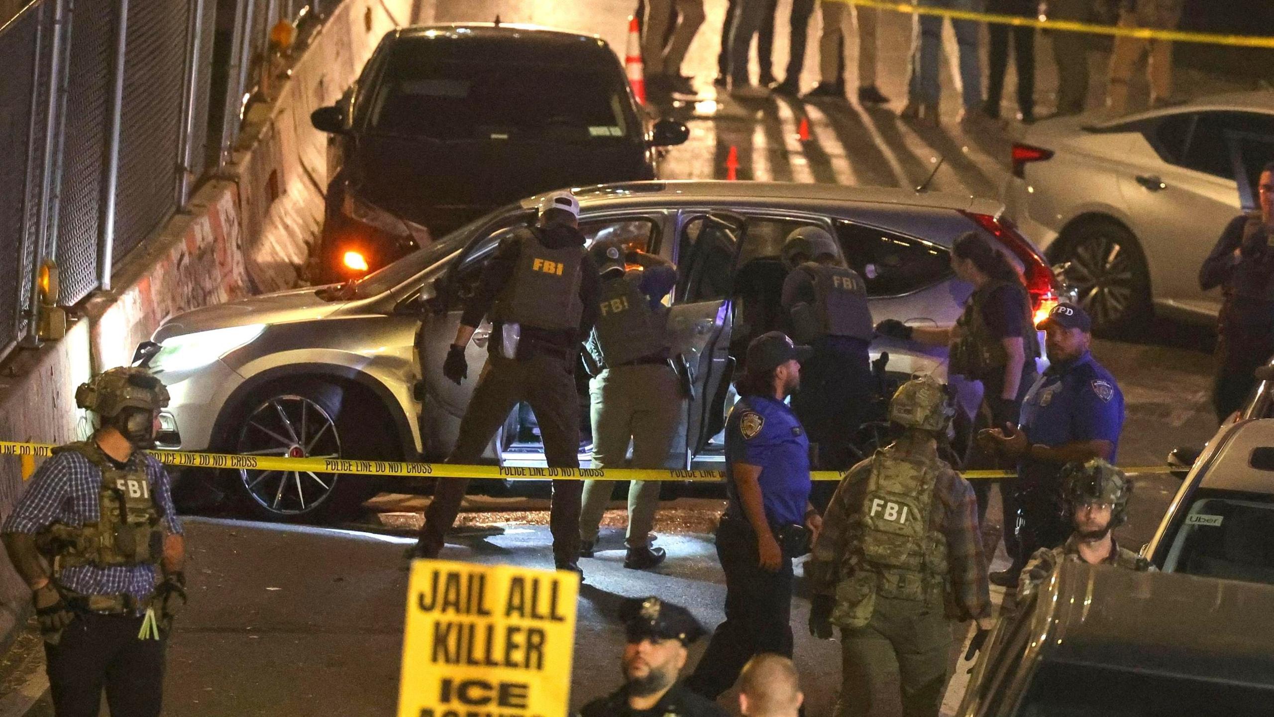 FBI officers searching a car at the scene